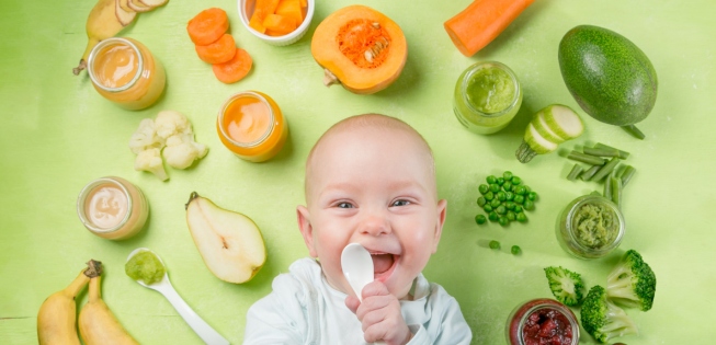 Baby surrounded by healthy food to eat